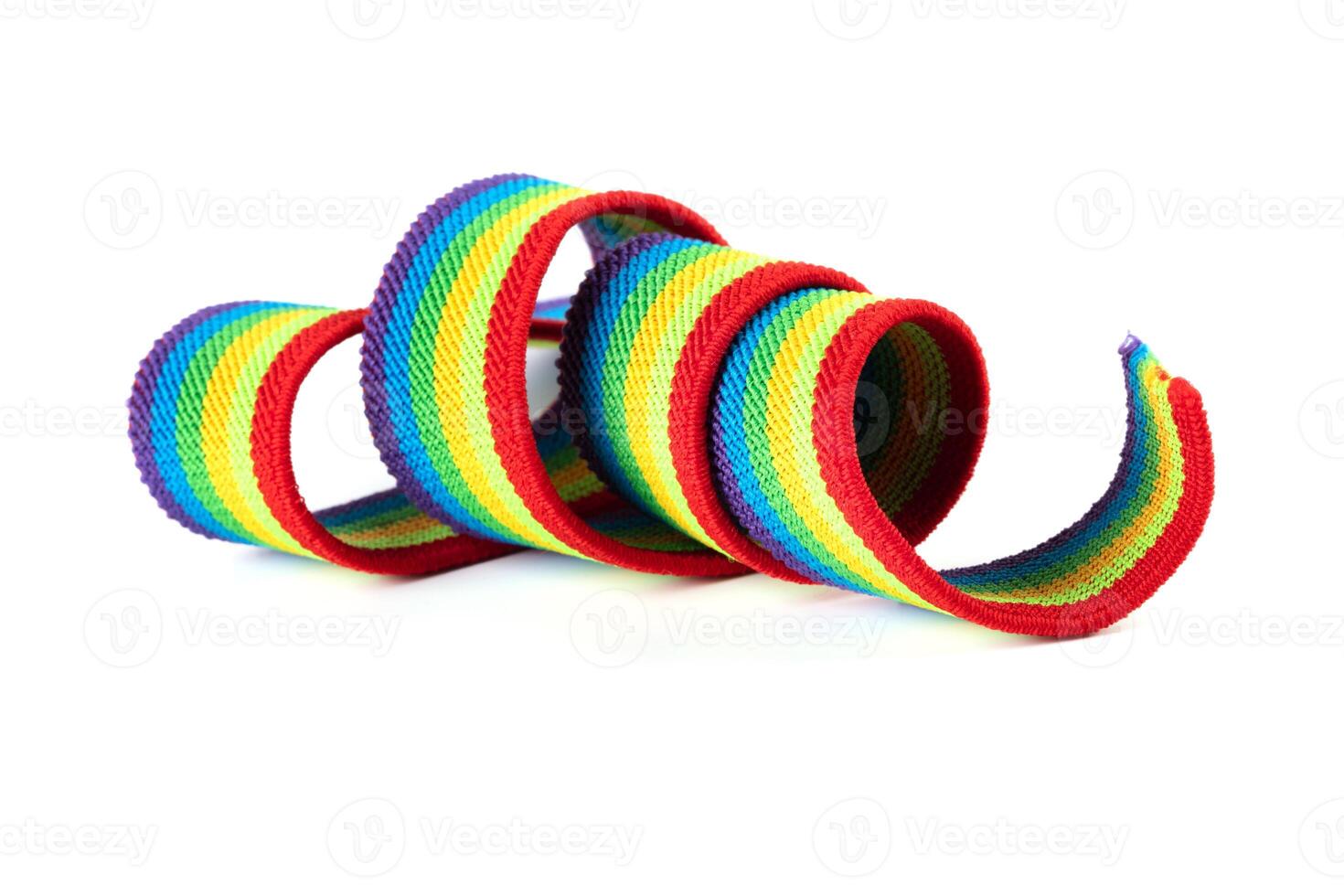 Colorful rainbow ribbon closeup isolated on white background. Colorful LGBT design. Curly, fluttering ribbon. photo