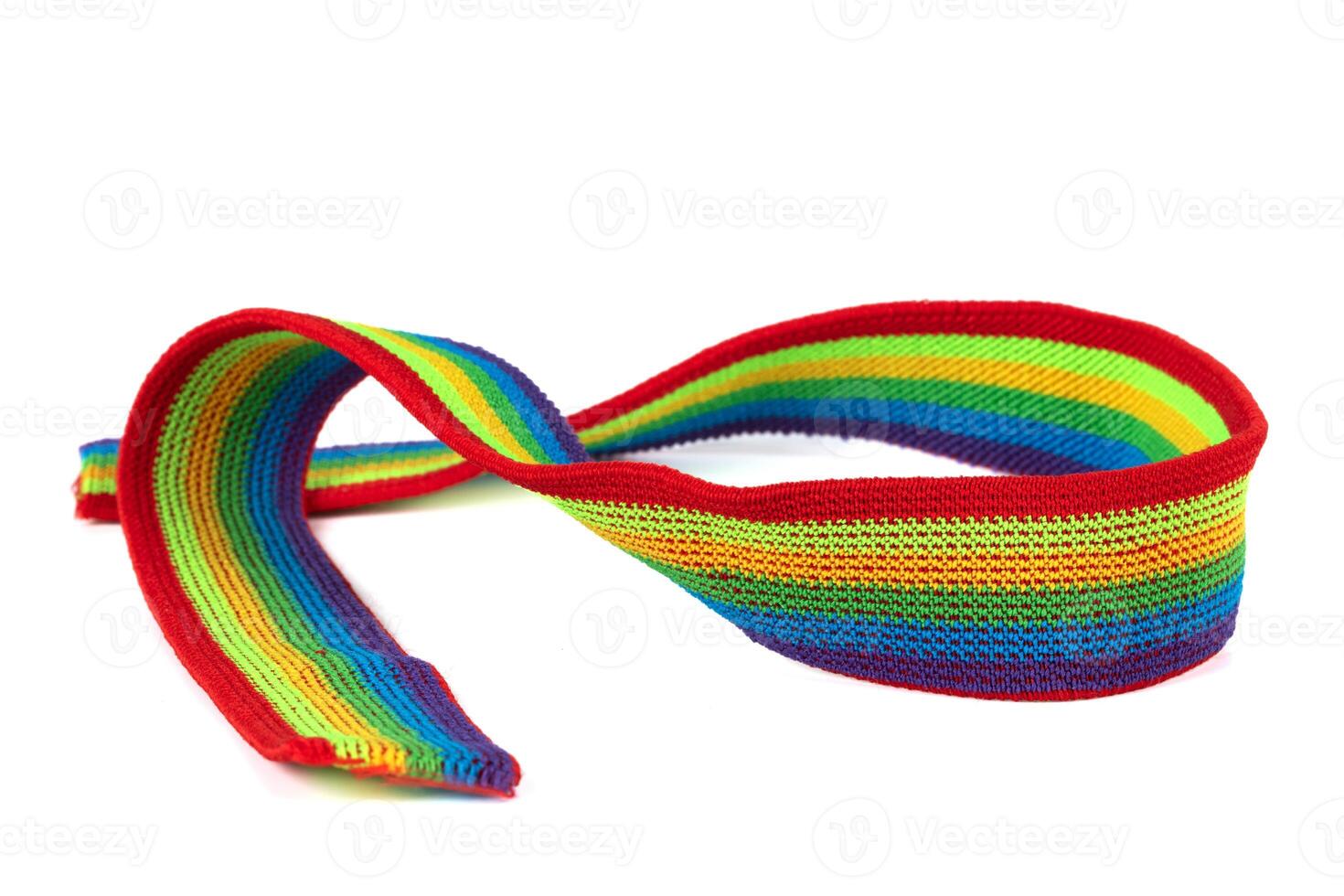 Colorful rainbow ribbon closeup isolated on white background. Colorful LGBT design. Curly, fluttering ribbon. photo