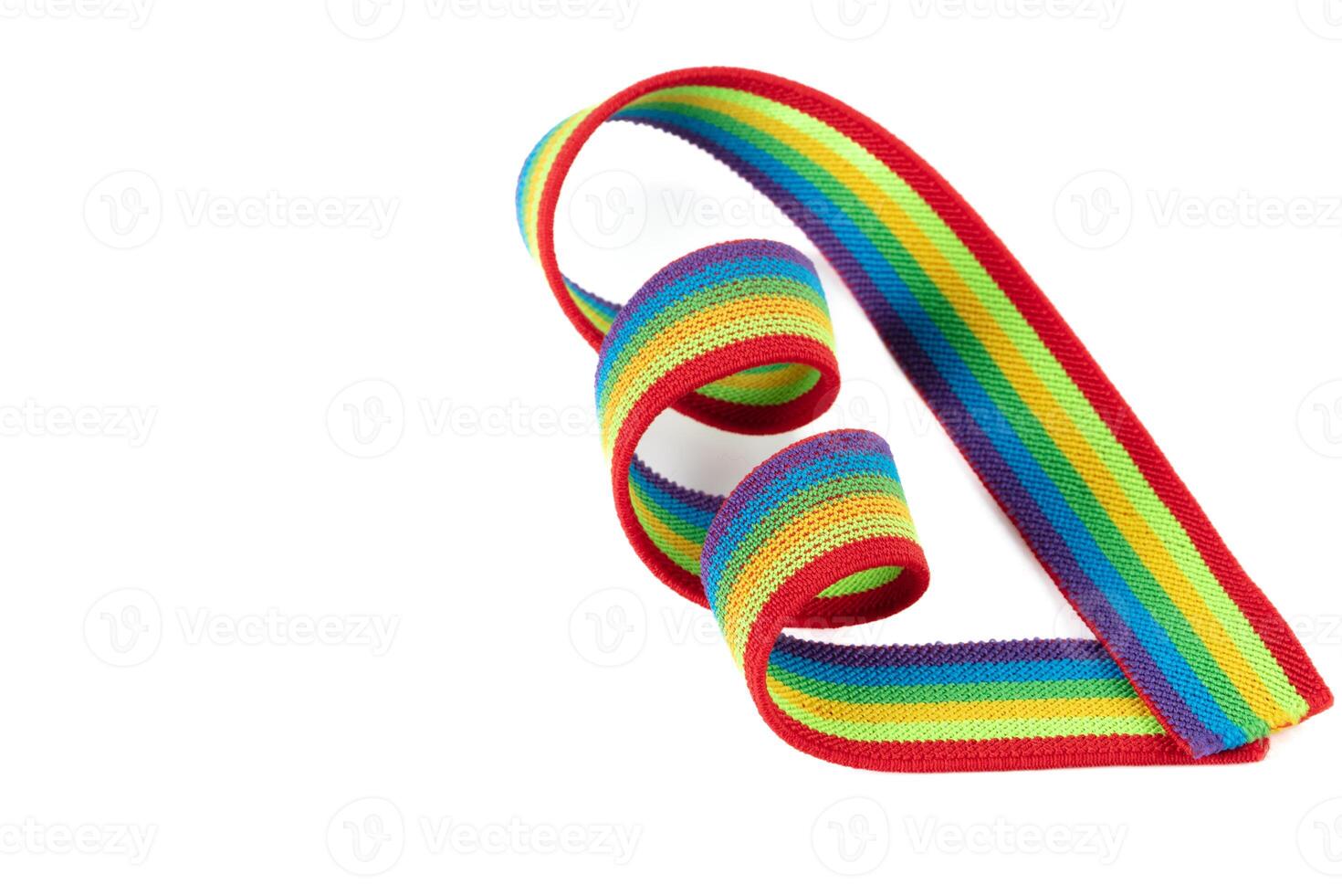 Colorful rainbow ribbon closeup isolated on white background. Colorful LGBT design. Curly, fluttering ribbon. photo