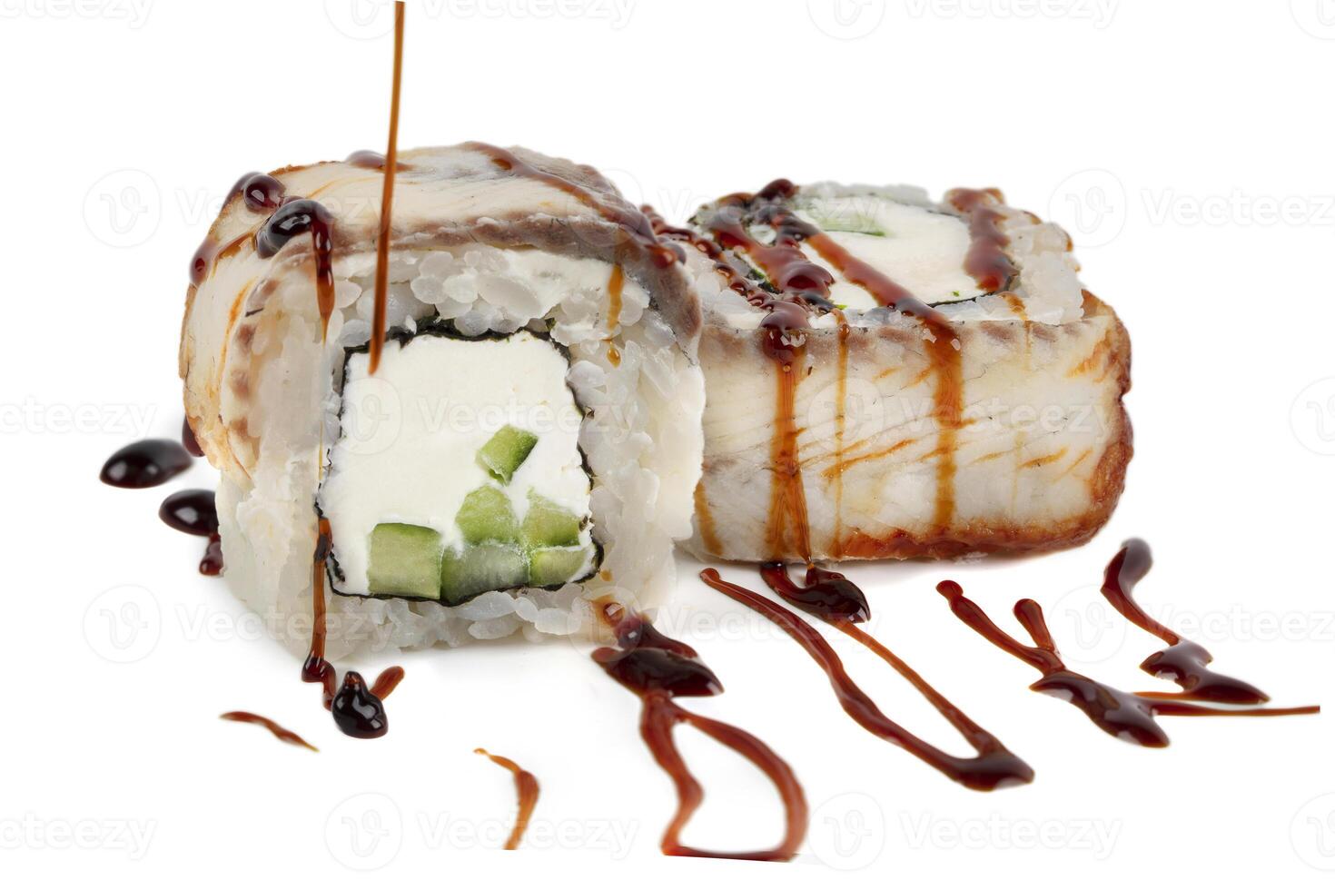 Sushi closeup isolated on white background. Sushi roll with graham rice, Philadelphia cheese and celery topped with soy sauce. Japanese restaurant menu. photo