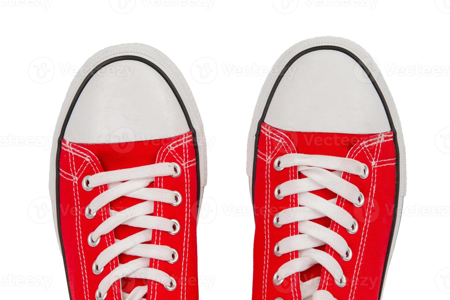 Part of red sneakers close-up on a white background, top view. photo