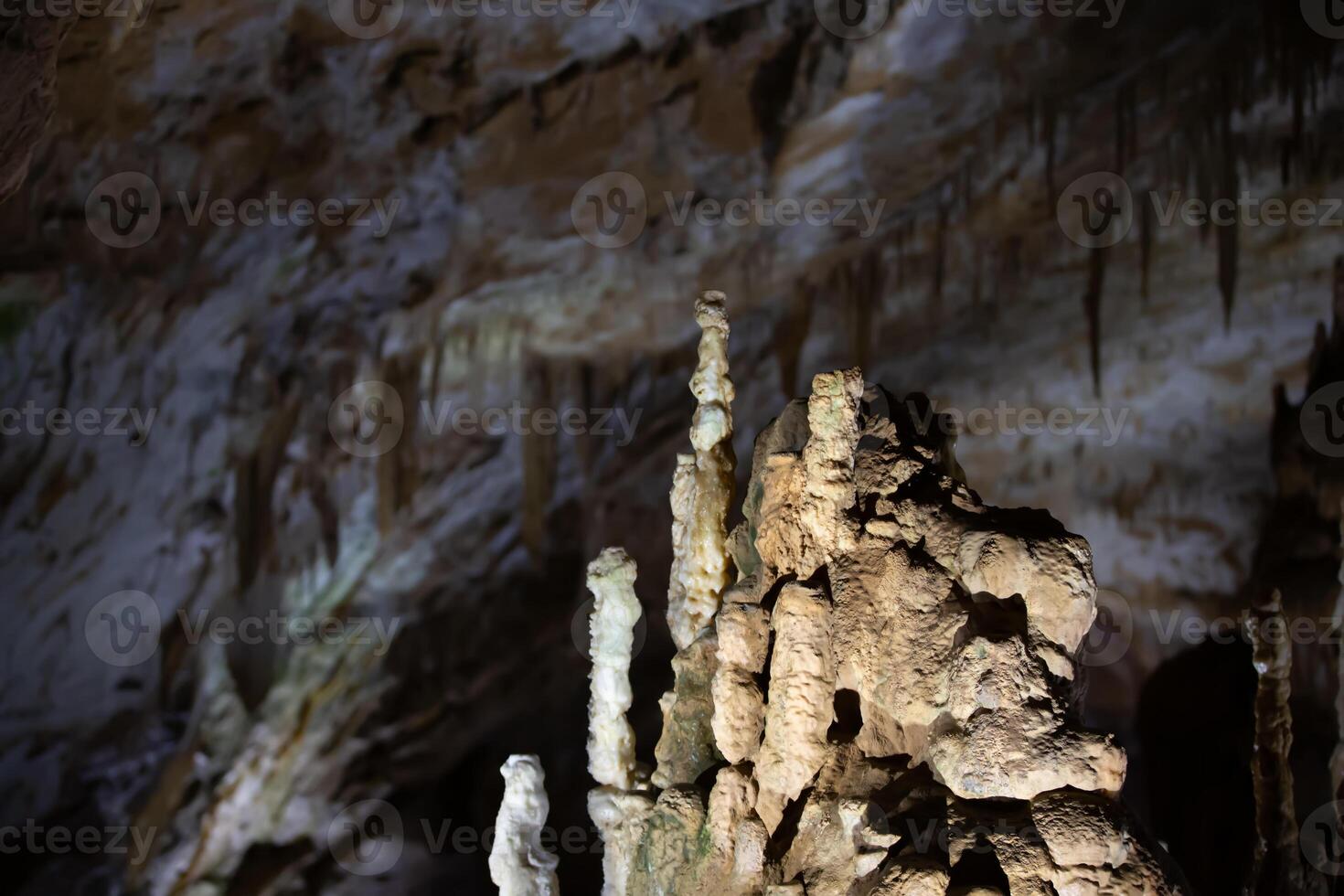 The cave is karst, amazing view of stalactites and stalagnites illuminated by bright light, a beautiful natural attraction in a tourist place. photo