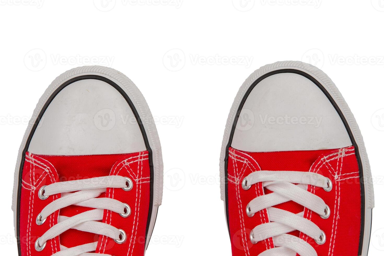 Red sneakers close-up on a white background, top view. photo