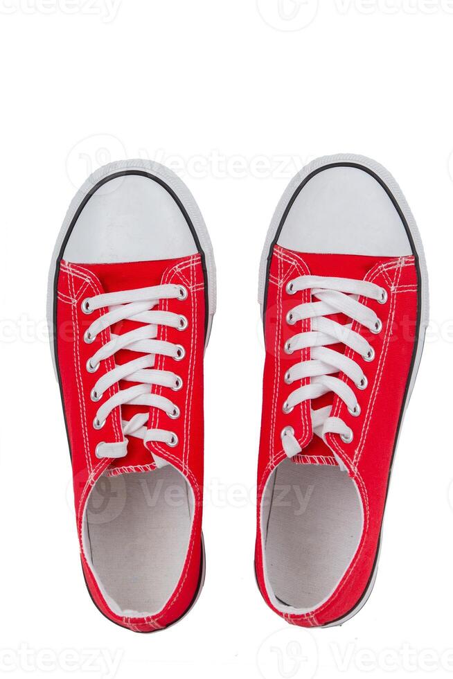 Red sneakers close-up on a white background, top view. photo