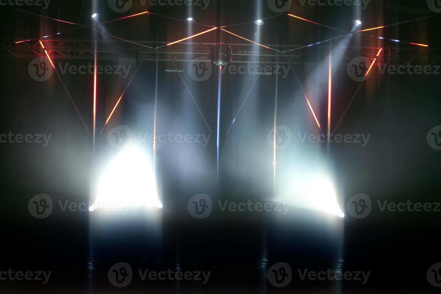 Stage lighting with laser illumination and puffs of smoke. Dark stage background. photo