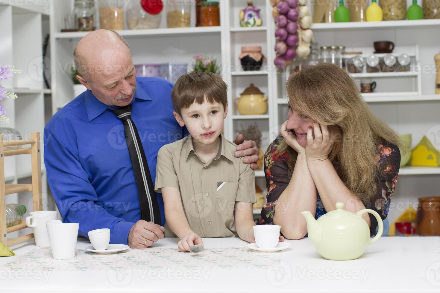 Grandpa with grandmother and grandson in the kitchen photo