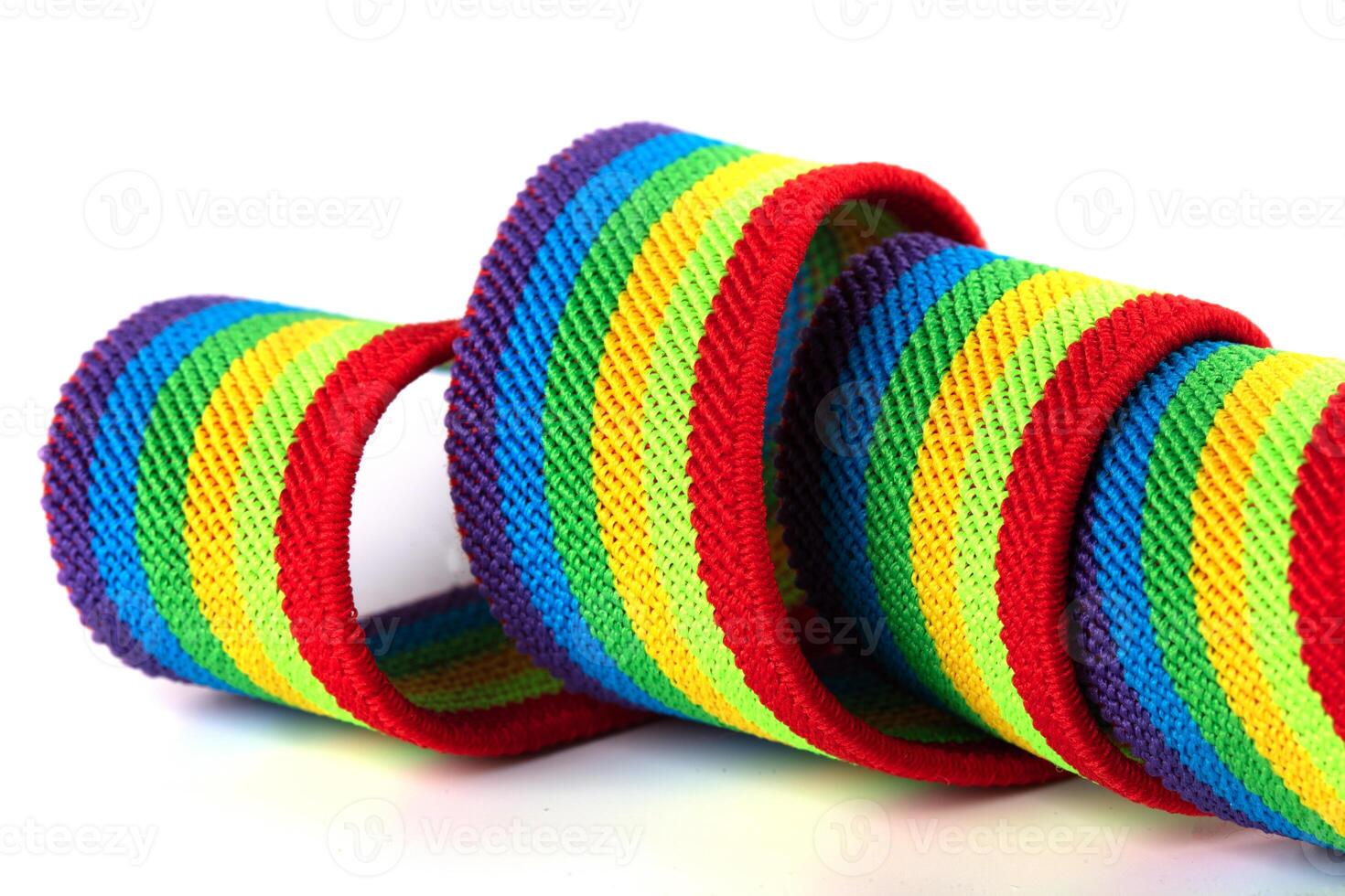 Colorful rainbow ribbon closeup isolated on white background. Colorful LGBT design. Curly, fluttering ribbon. photo