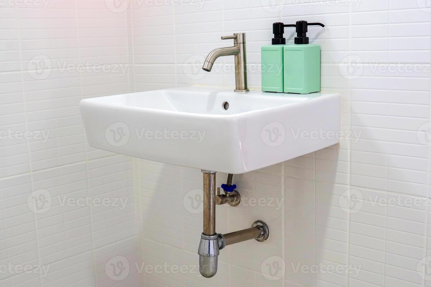 A hanging rectangular ceramic washbasin is a bathroom sanitary ware that is easy to install and beautiful. soft and selective focus. photo