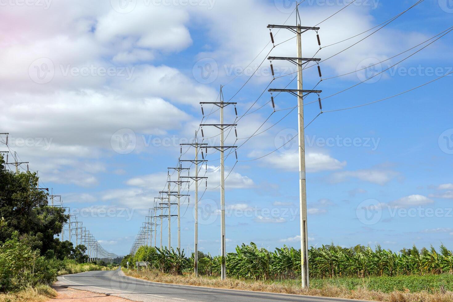 The lines of electric poles along the road look beautiful. It is a type of equipment that serves to support the installation of electrical wires above the ground. soft and selective focus. photo