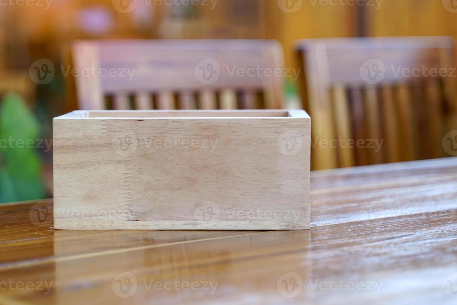 A wooden box for putting things on a wooden table. Soft and selective focus. photo