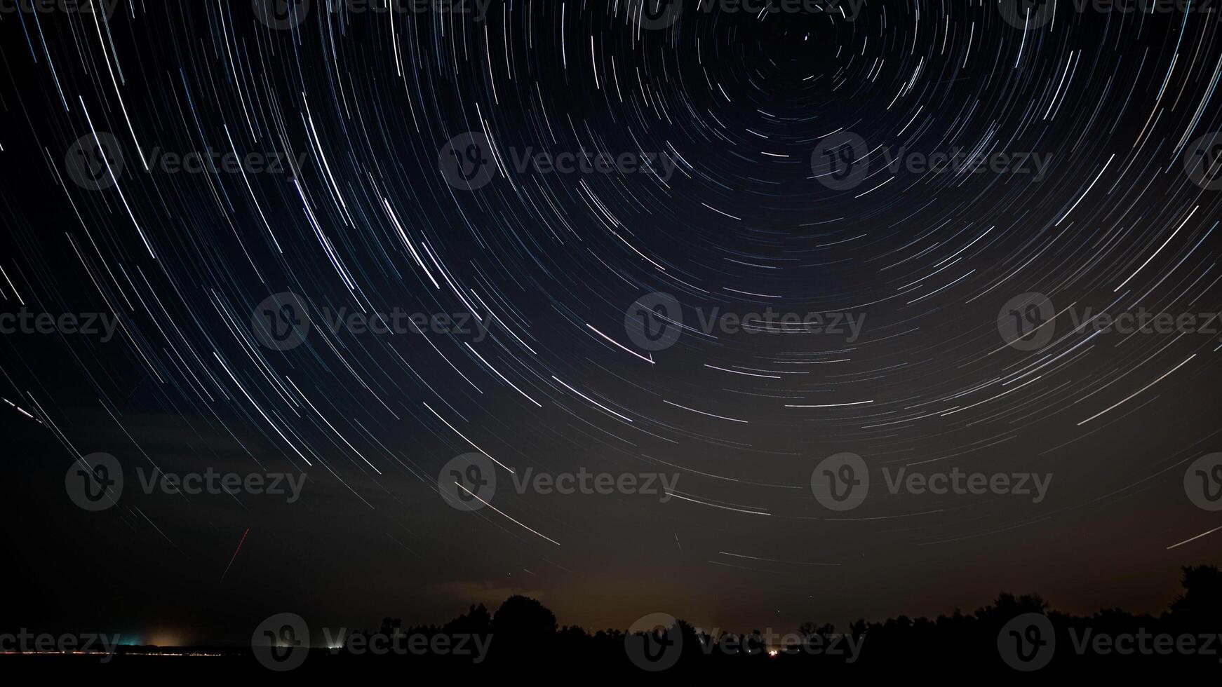 Star trails in the night sky. Stars move around a polar star photo