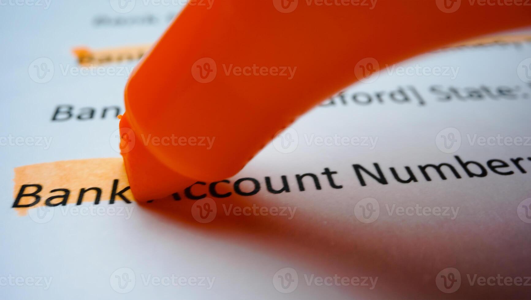 Close-up hand with yellow marker pen highlighting bank account number on the deposit money, account statement photo