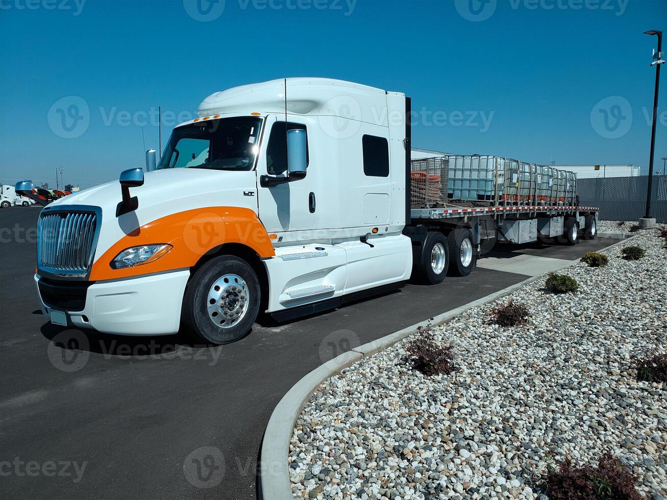 A tractor-trailer truck in a parking lot. photo