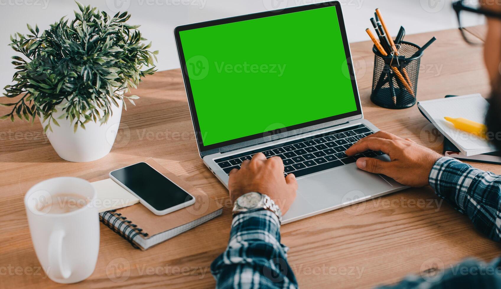 Mockup image of laptop with blank white screen and Smartphone on wooden table of In the office shop, Green screen. chroma key ultra key photo