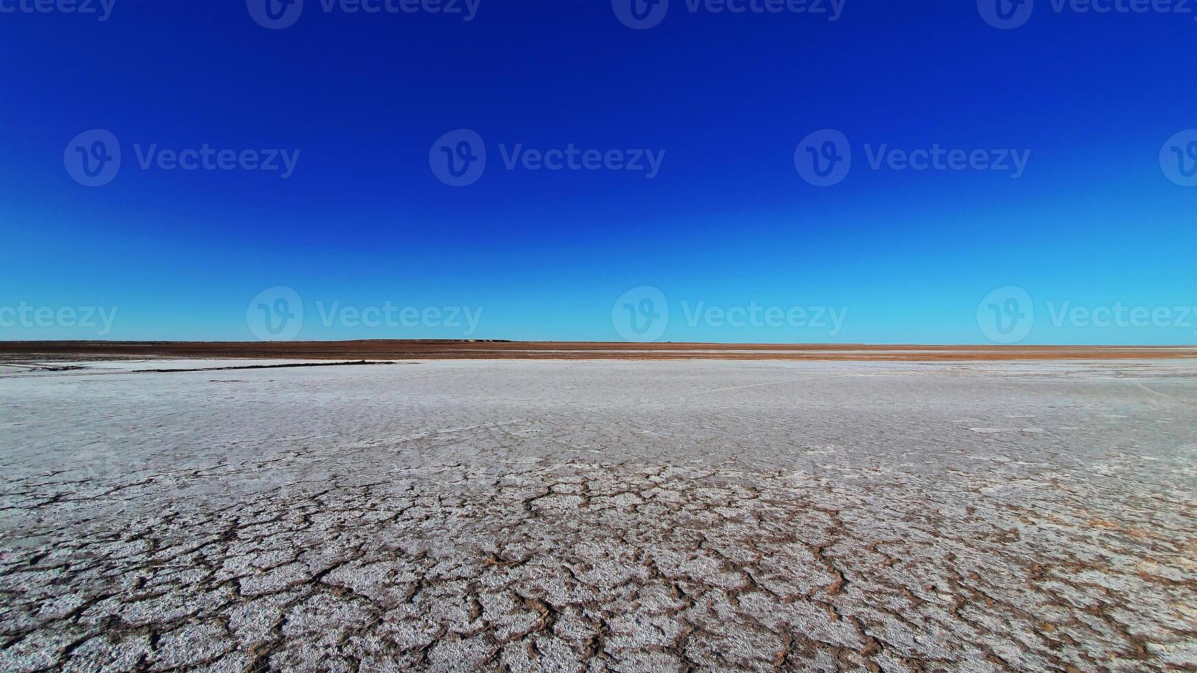 Dry lake or swamp in the process of drought and lack of rain or moisture, a global natural disaster - aerial drone view photo