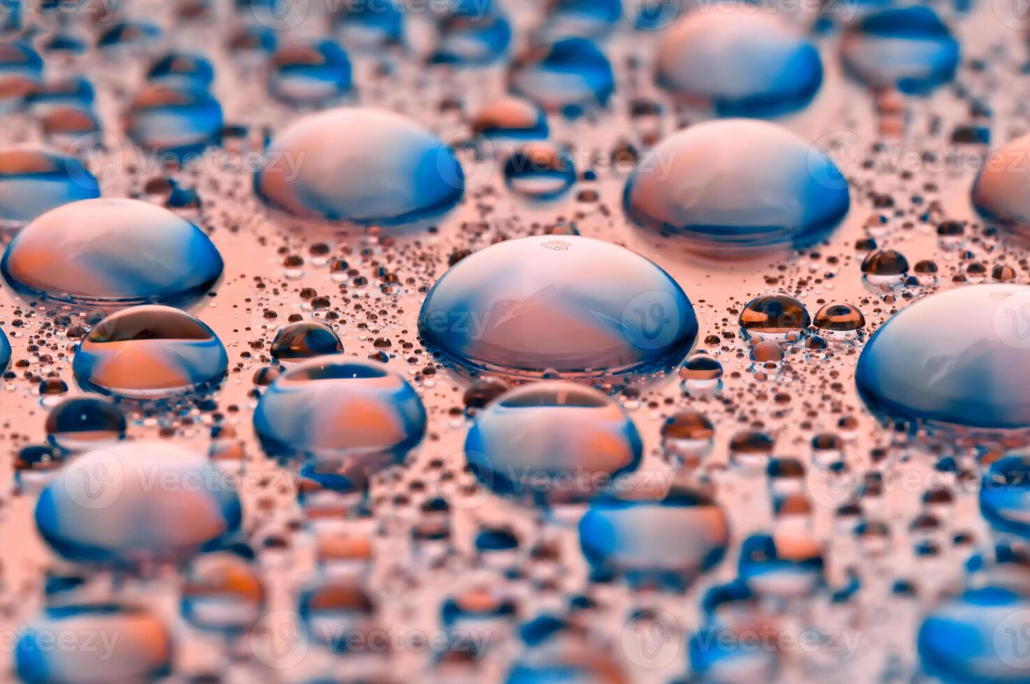 Drops of water. Abstract background. Macro texture of many drops. Rainbow color gradient. Heavily textured image. Shallow depth of field. Selective soft focus photo