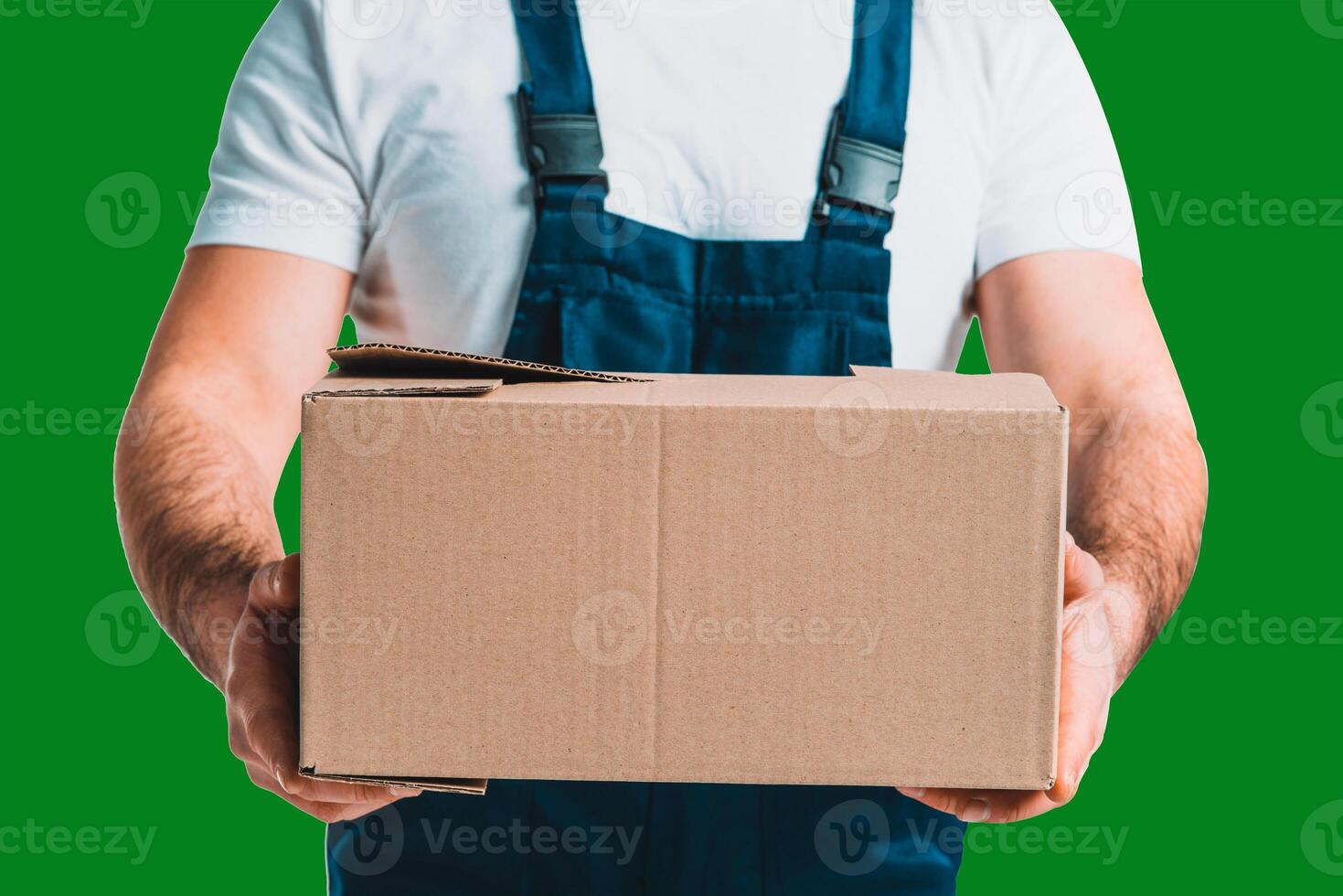 Young delivery man hold a cardboard box in his hands with Green Screen chroma key ultra key photo
