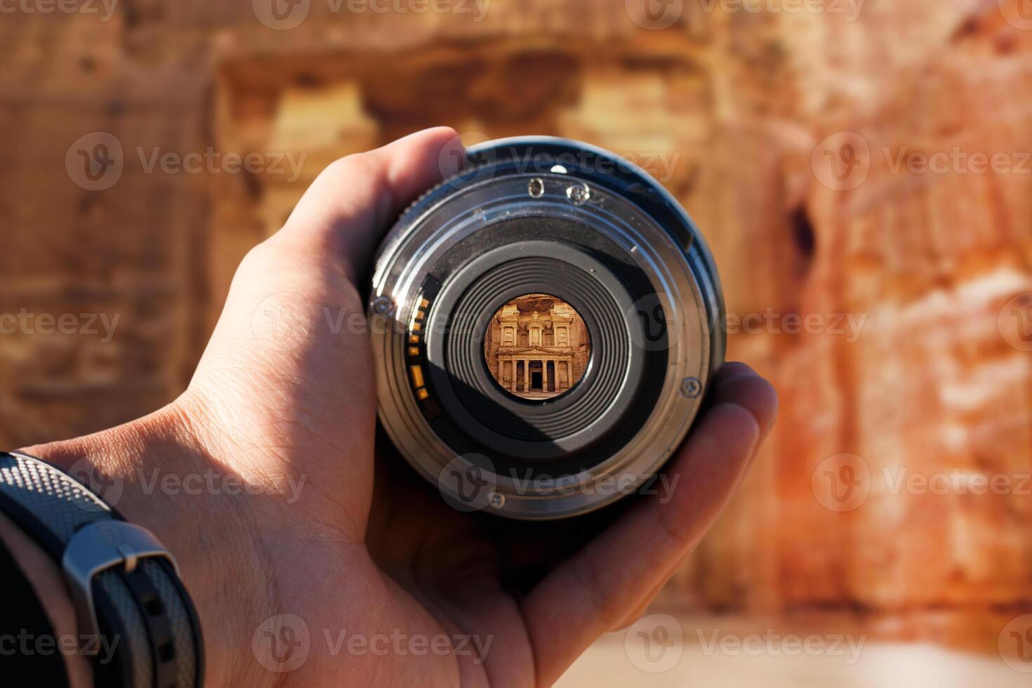 selective focus shot person holding camera lens on Petra tourist taking a picture with camera lens on Petra photo