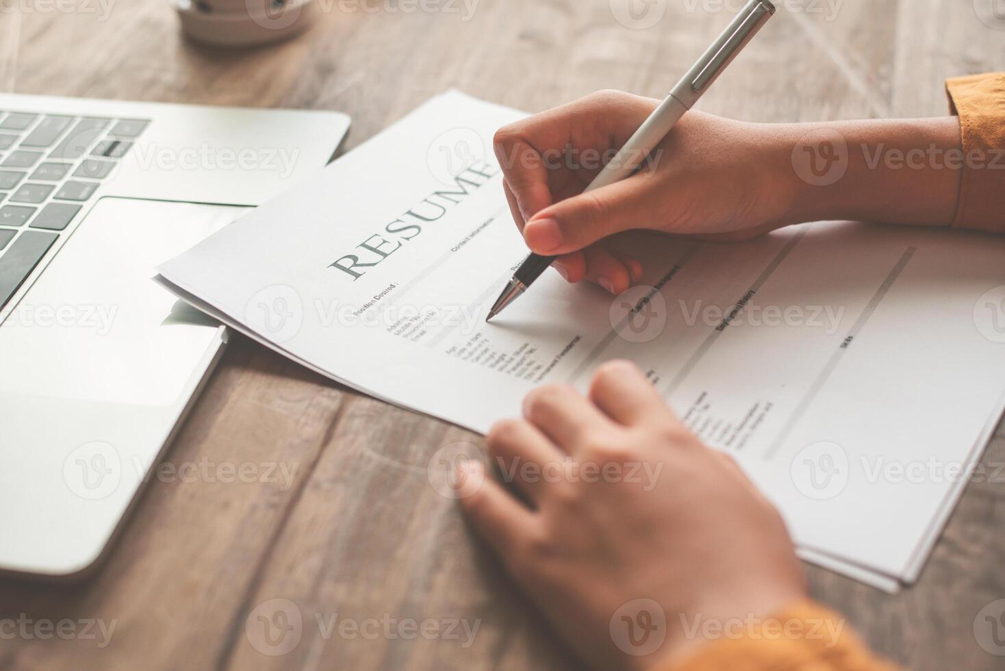 People are filling out their resume on the job application form to apply for a job at a company. photo