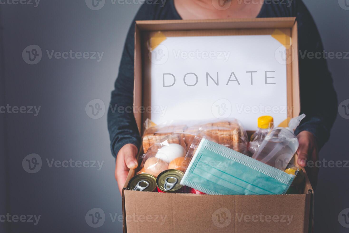 Volunteers with donation boxes for the needy and provide essential supplies to help during the plague Covid-19. photo