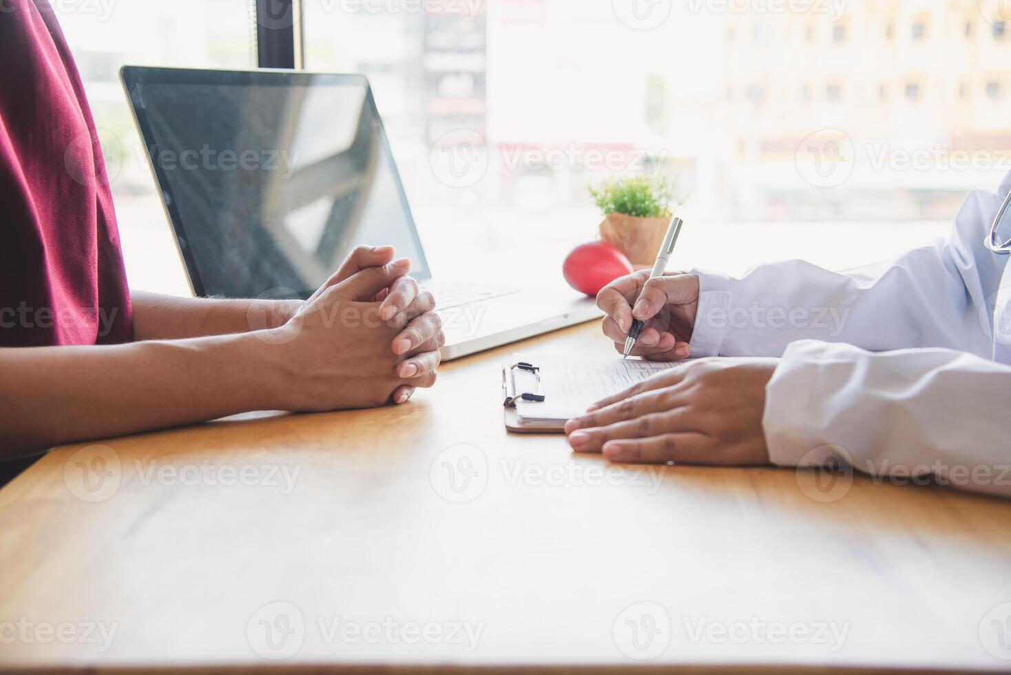 The doctor is discussing with the patient after a physical examination of the results and treatment guidelines. photo