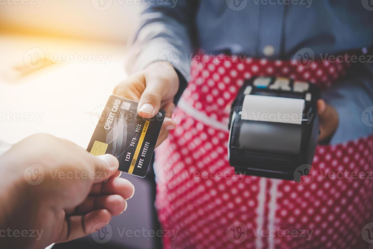 Paying by credit card , buying and selling products using a credit card swipe machine photo