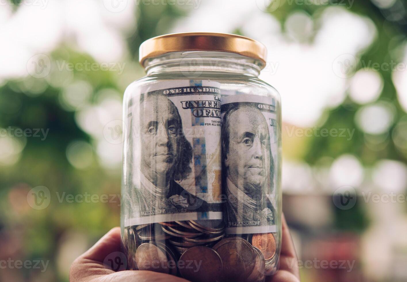 Hand  holding jar in coins  saving money,  finance and investment Concept photo