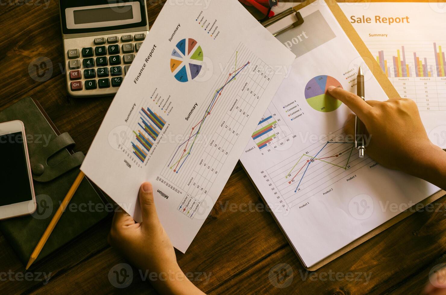 Businessman holding paperwork on the table and analyzing investment chart working in office. Business work concept. photo