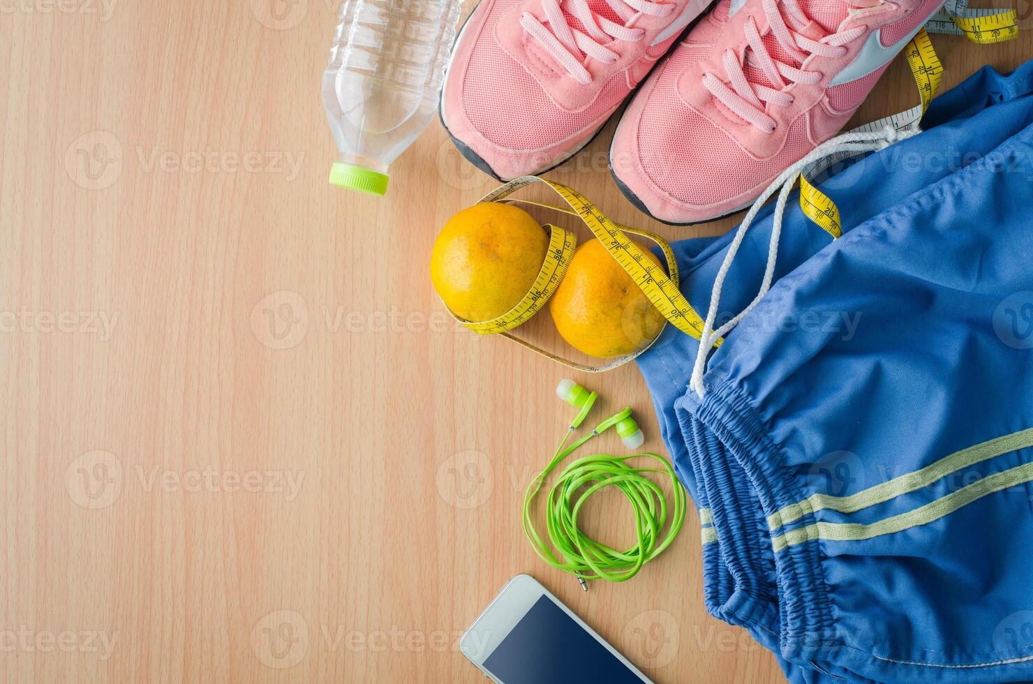 fitness concept with Exercise Equipment on wooden background. photo