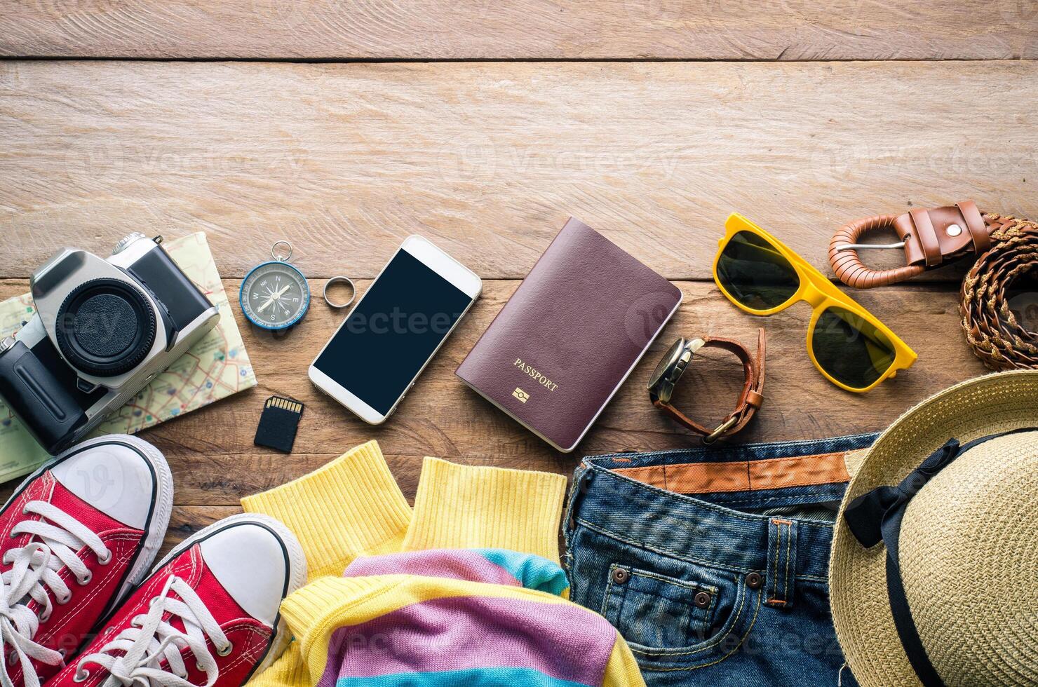 Travel accessories on wooden floor ready for travel photo