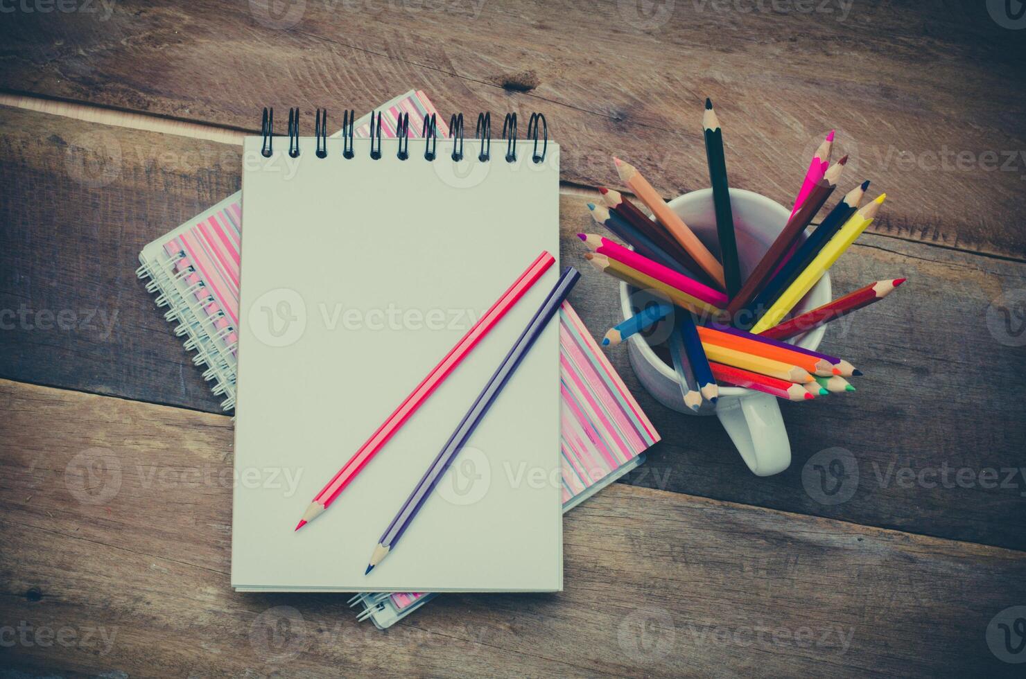 Color pencil and sketchbook on wooden background photo