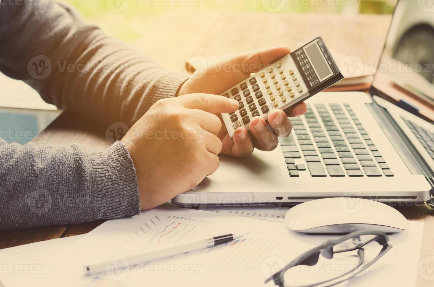 Working on a desk numerical analysis, financial accounting. Graphing photo
