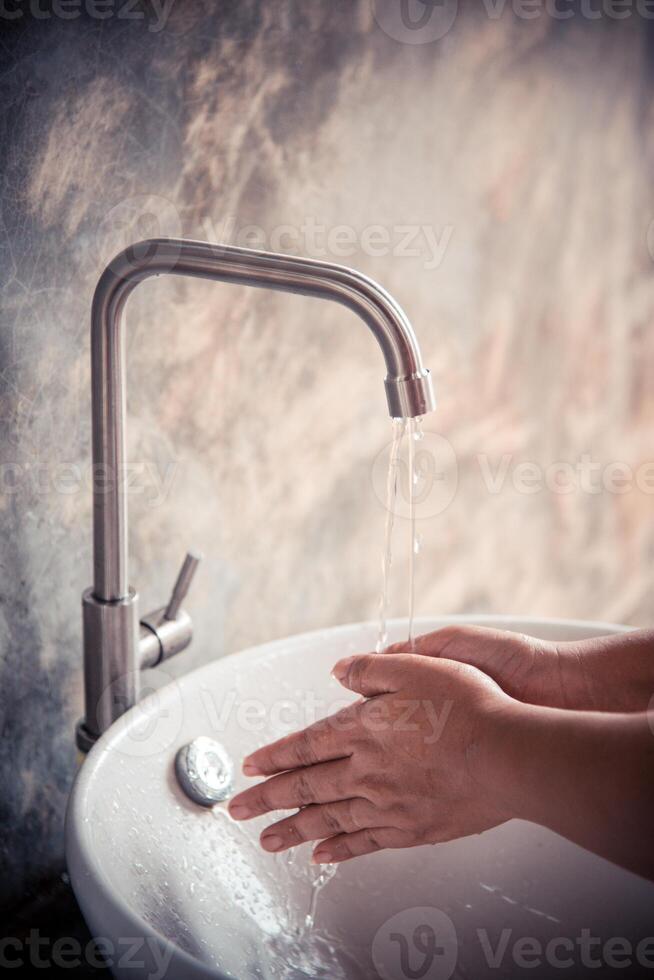 Washing hands in the sink photo