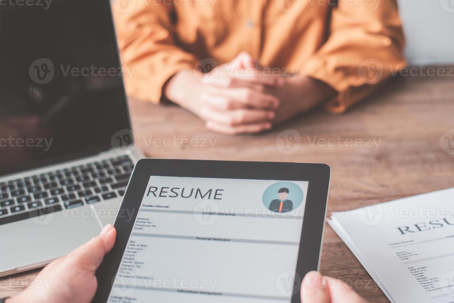 HR managers are interviewing job applicants who fill out their resume on the job application form in order to consider accepting a job as a company. photo