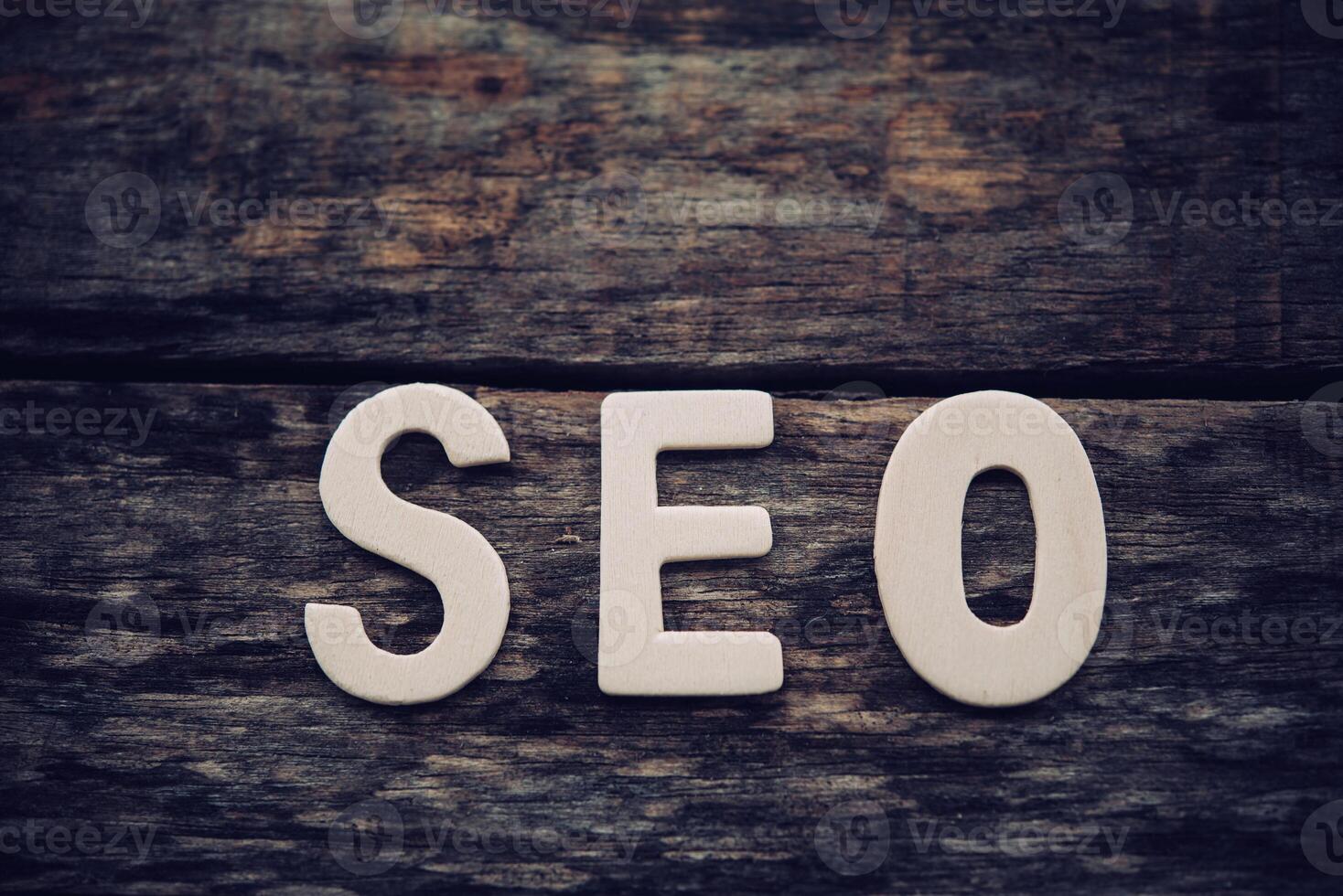 Place the word  S E O on the wooden floor - concept Search Engine Optimization photo