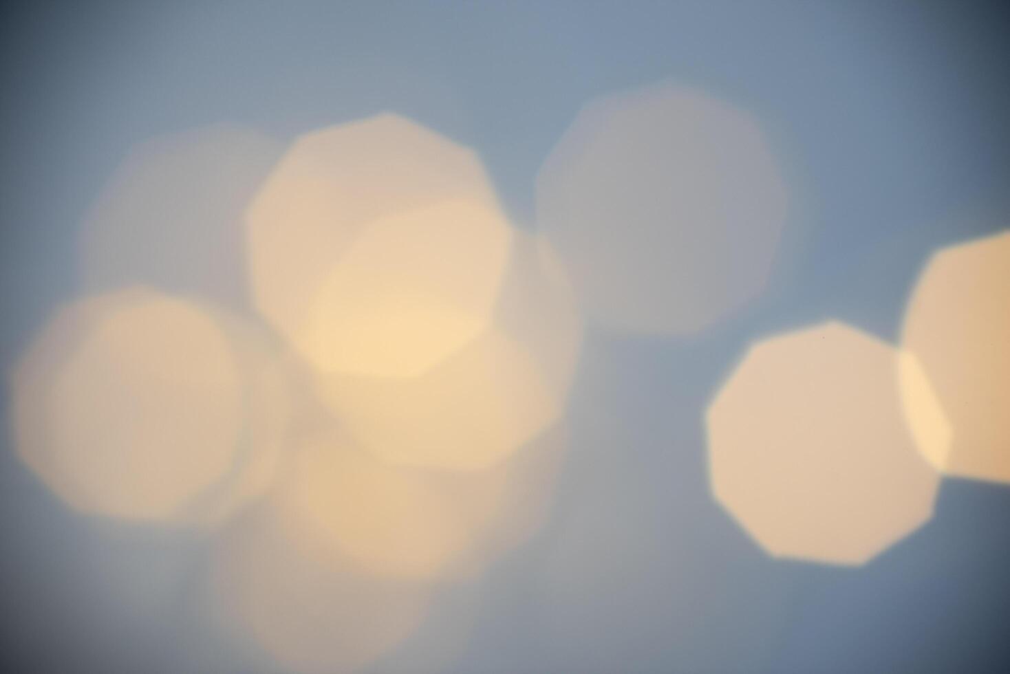 a blurry image of a light bulb with a blue sky photo
