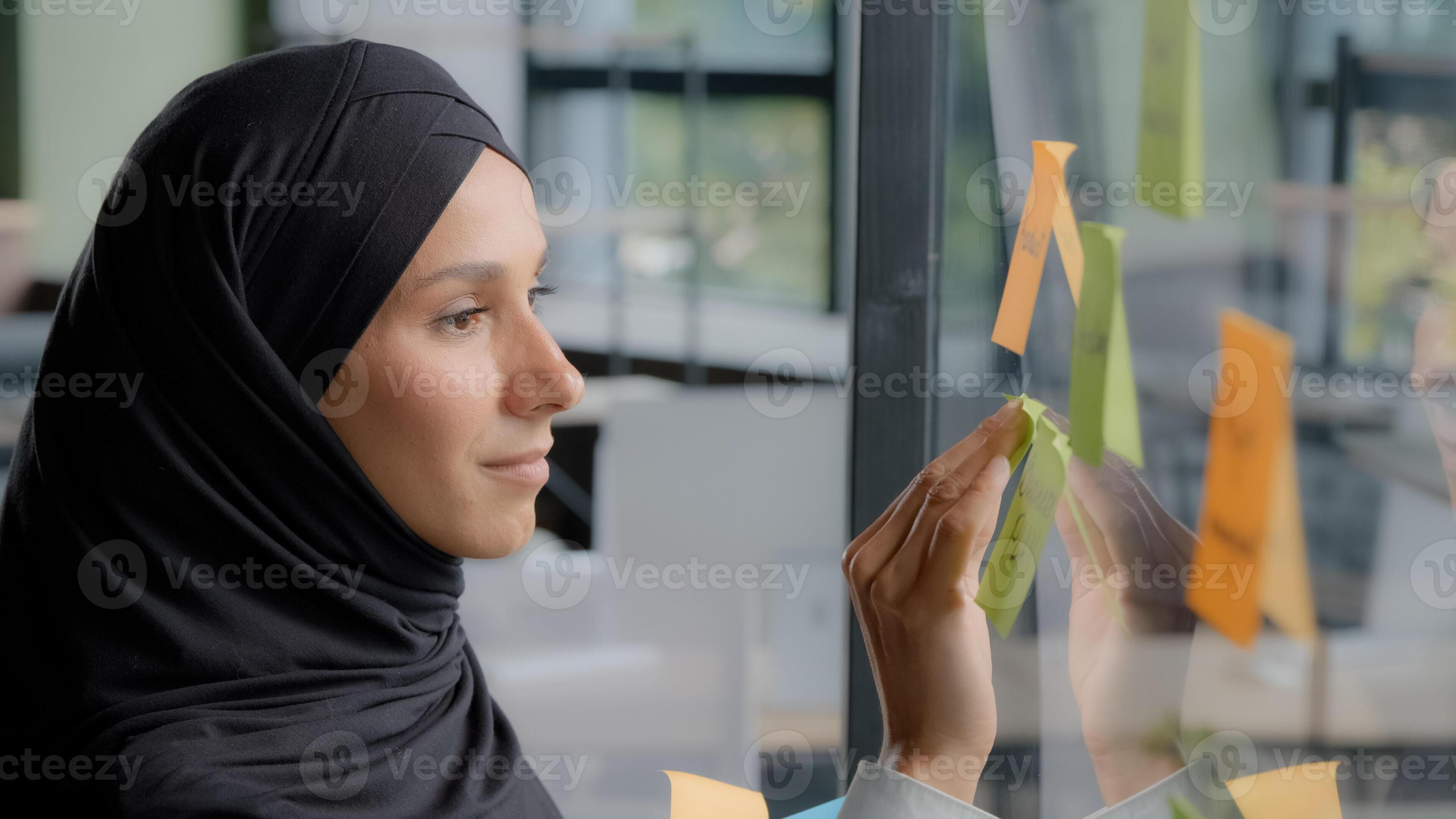 Smiling successful businesswoman corporate leader writing project tasks