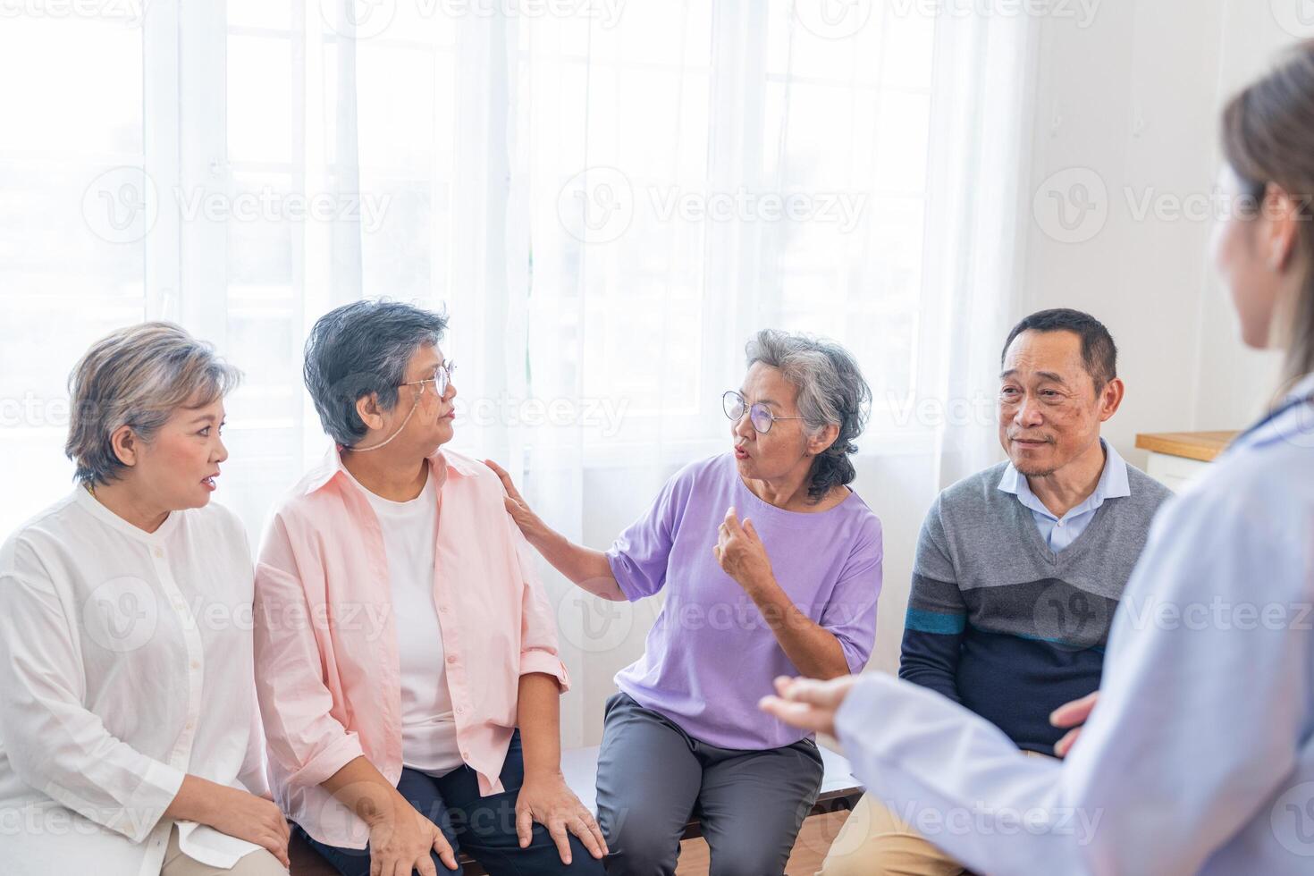 senior females and male sitting on bench. older people are listening and enjoy meeting focus group at living room. Joyful carefree retired senior friends enjoying relaxation at nearly home. photo