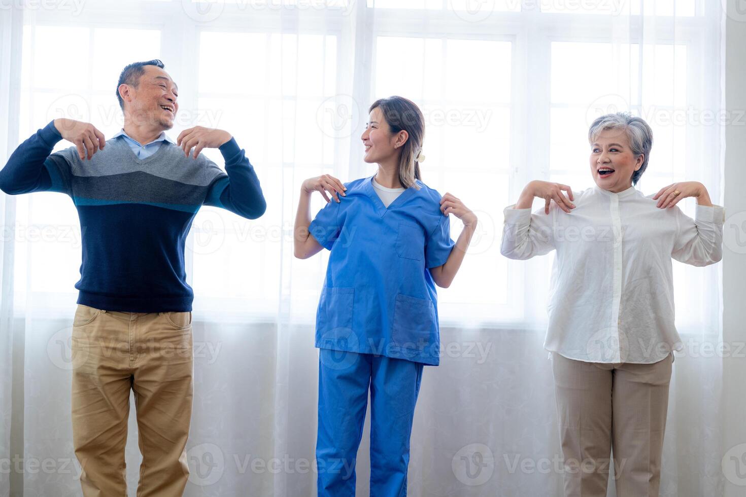 Portrait of elderly smiling Asian woman and people aerobics in nursery house. Seniors are moving their body arms and shoulders for a healthy life. retired people activities group concept. photo