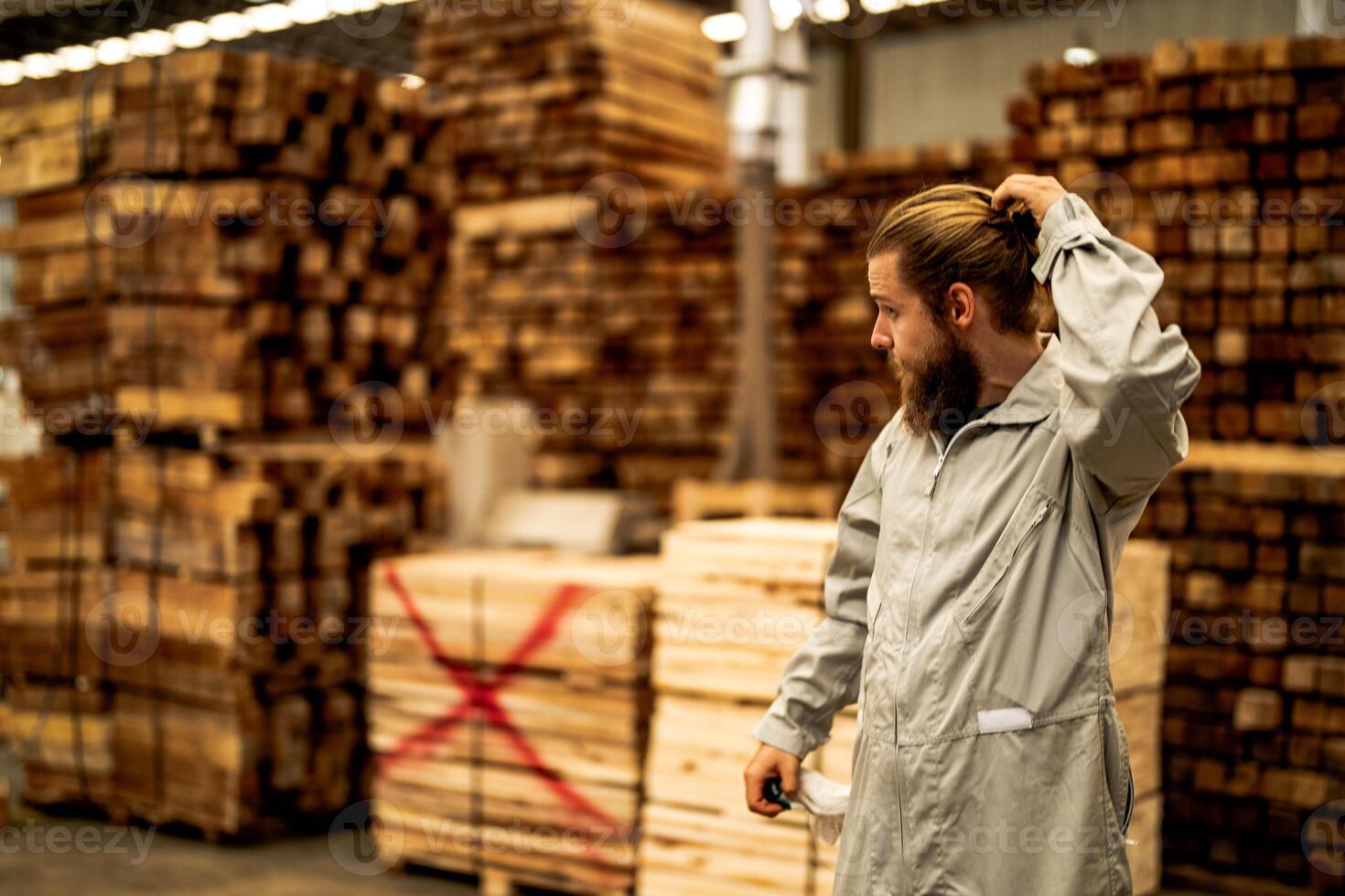 man workers engineering standing with confidence with working suite dress and hand glove in front machine. Concept of smart industry worker operating. Wood factory produce wood palate. photo