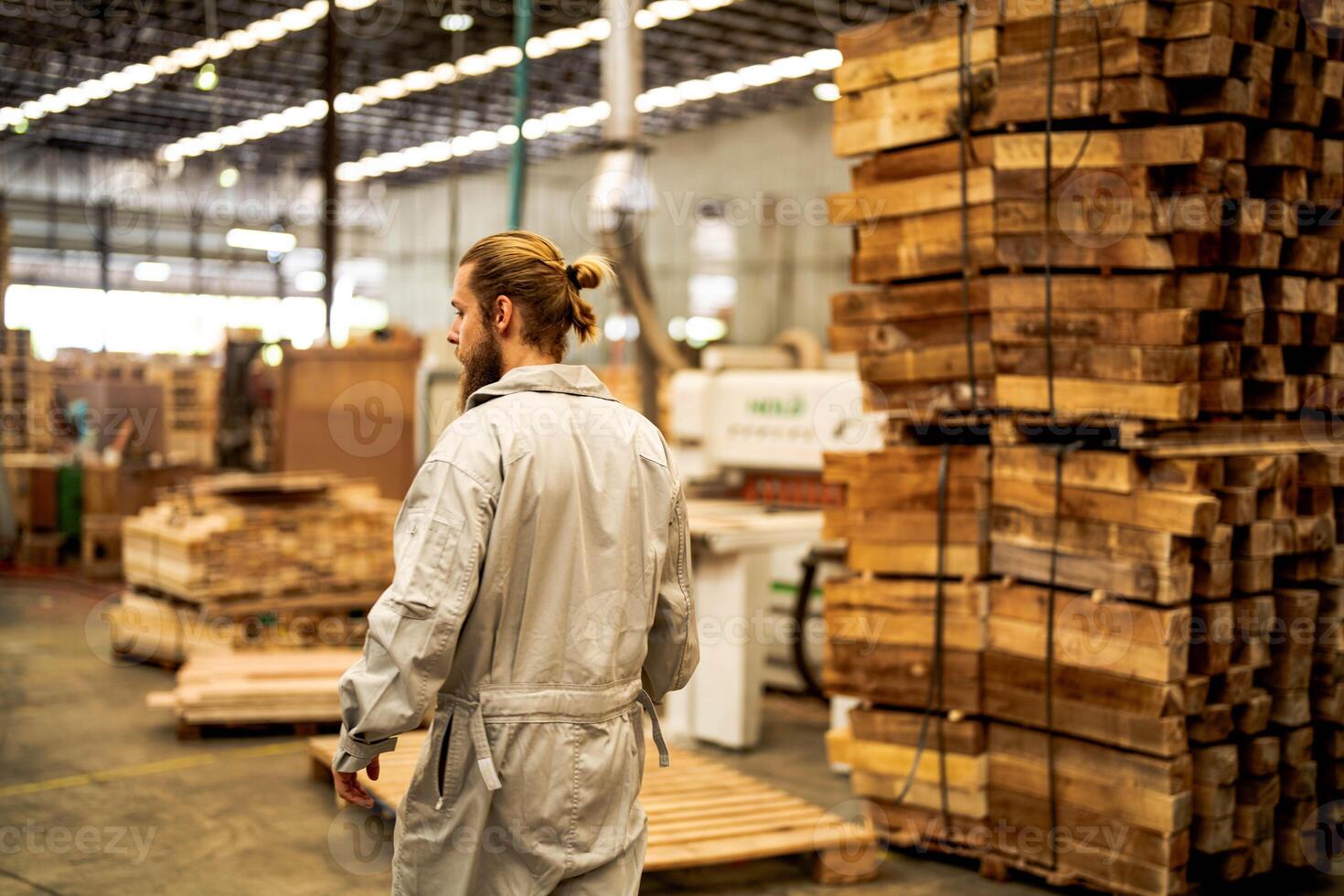 man workers engineering standing with confidence with working suite dress and hand glove in front machine. Concept of smart industry worker operating. Wood factory produce wood palate. photo