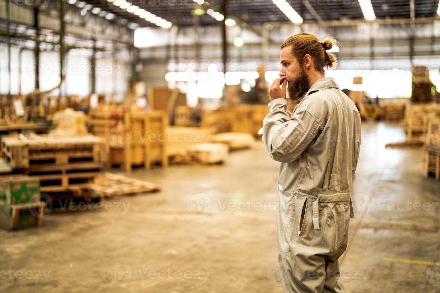 man workers engineering standing with confidence with working suite dress and hand glove in front machine. Concept of smart industry worker operating. Wood factory produce wood palate. photo