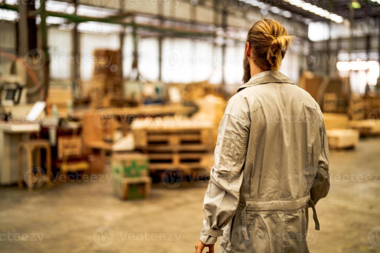 man workers engineering standing with confidence with working suite dress and hand glove in front machine. Concept of smart industry worker operating. Wood factory produce wood palate. photo