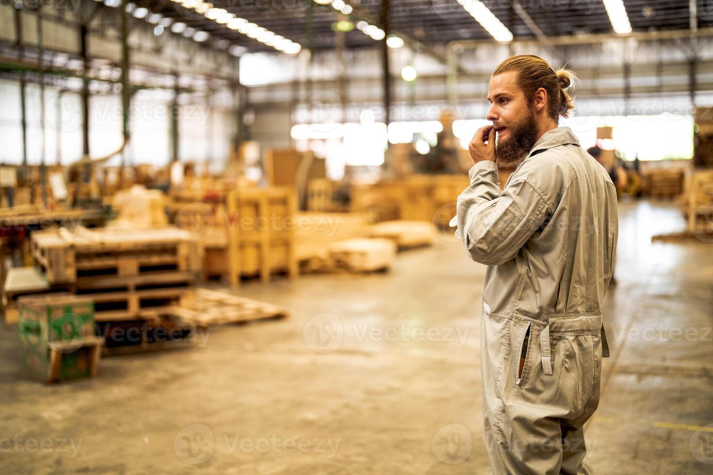 man workers engineering standing with confidence with working suite dress and hand glove in front machine. Concept of smart industry worker operating. Wood factory produce wood palate. photo