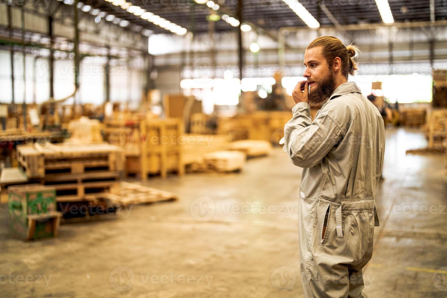 man workers engineering standing with confidence with working suite dress and hand glove in front machine. Concept of smart industry worker operating. Wood factory produce wood palate. photo