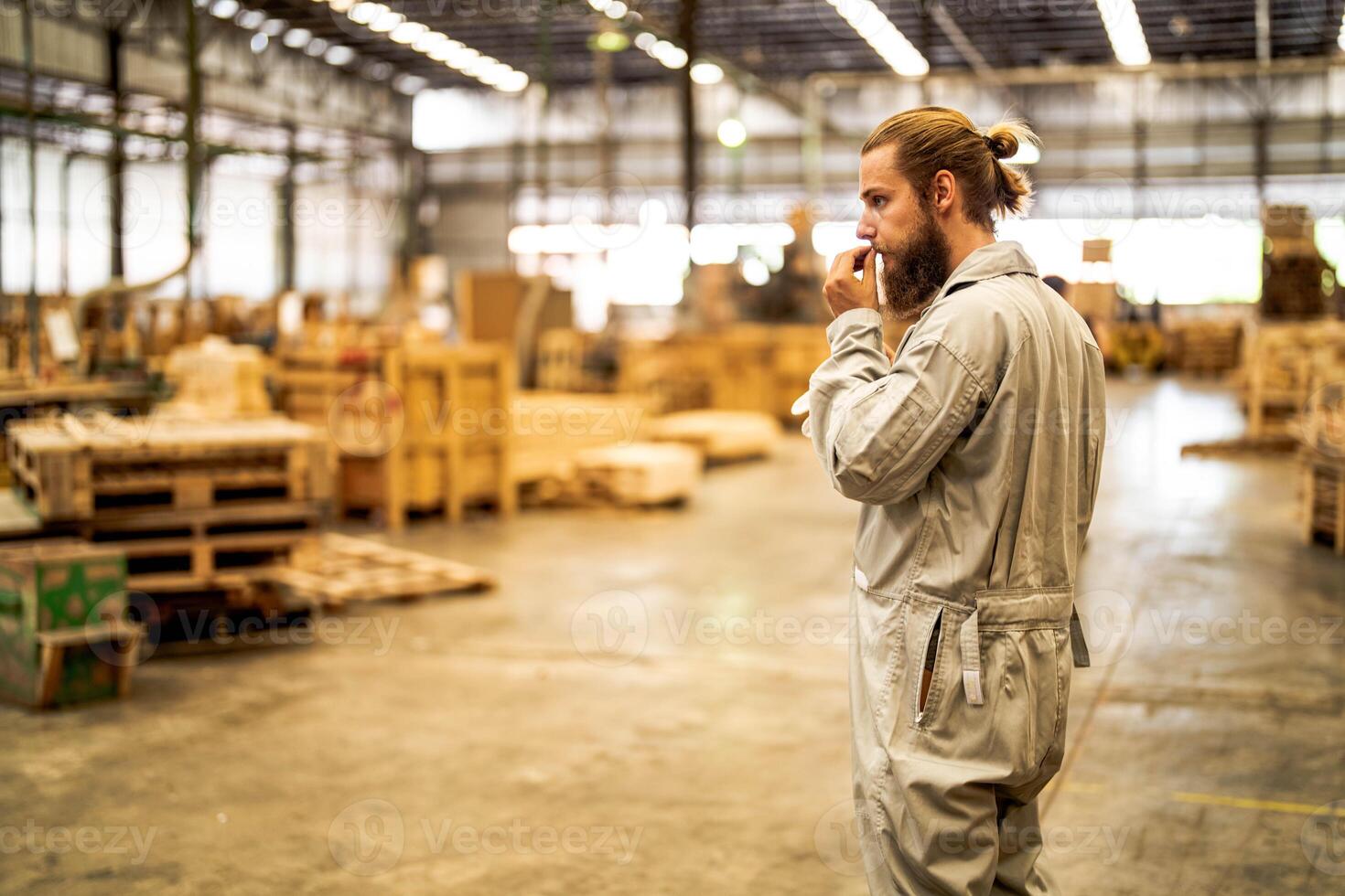 man workers engineering standing with confidence with working suite dress and hand glove in front machine. Concept of smart industry worker operating. Wood factory produce wood palate. photo