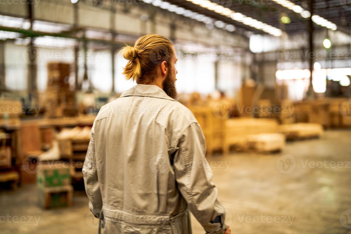 man workers engineering standing with confidence with working suite dress and hand glove in front machine. Concept of smart industry worker operating. Wood factory produce wood palate. photo