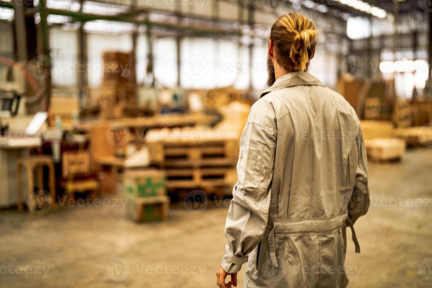 man workers engineering standing with confidence with working suite dress and hand glove in front machine. Concept of smart industry worker operating. Wood factory produce wood palate. photo