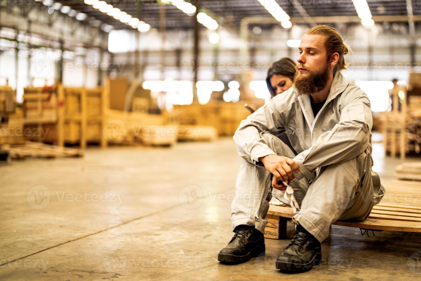 man workers engineering sitting with confidence with working suite dress and hand glove in front machine. Concept of smart industry worker operating. Wood factory produce wood palate. photo