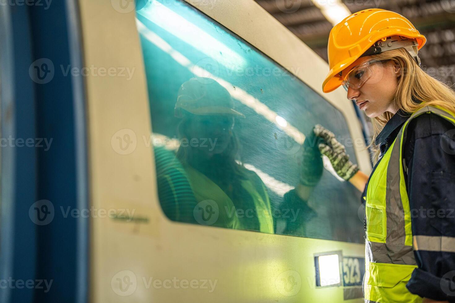 Factory engineer woman standing confidence to control panel switch. Worker works at heavy machine at industry factory. with machinery equipment plant technology. smart industry worker operating. photo